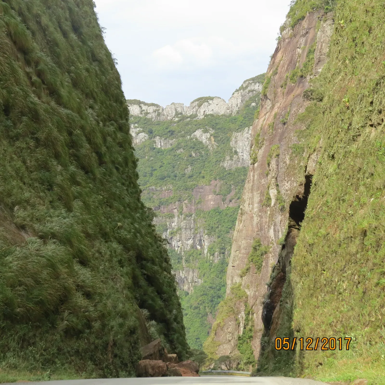 Corte estreito entre dois paredões de pedra cobertos de mata, na Serra do Corvo Branco, antes da pavimentação
